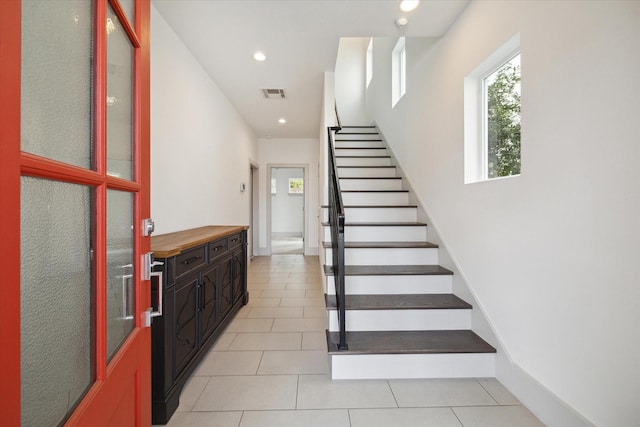 stairs with recessed lighting, visible vents, baseboards, and tile patterned floors