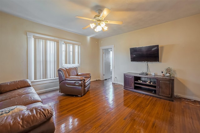 living room with a ceiling fan, baseboards, and hardwood / wood-style flooring