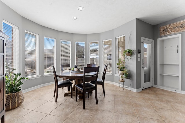 dining space featuring light tile patterned floors, baseboards, a textured ceiling, and recessed lighting