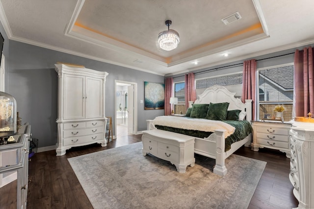 bedroom featuring visible vents, a raised ceiling, dark wood-type flooring, and baseboards