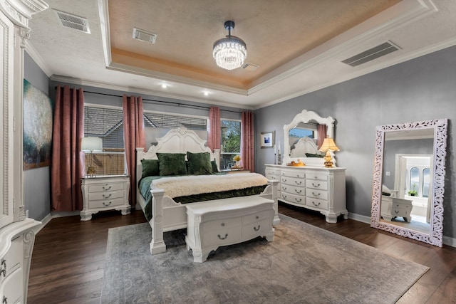 bedroom featuring visible vents, ornamental molding, a raised ceiling, and hardwood / wood-style floors