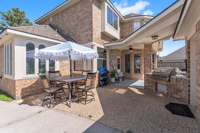 view of patio featuring area for grilling, fence, grilling area, outdoor dining area, and ceiling fan