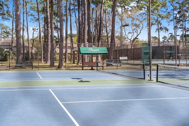 view of tennis court with fence