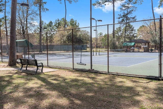 view of tennis court with fence