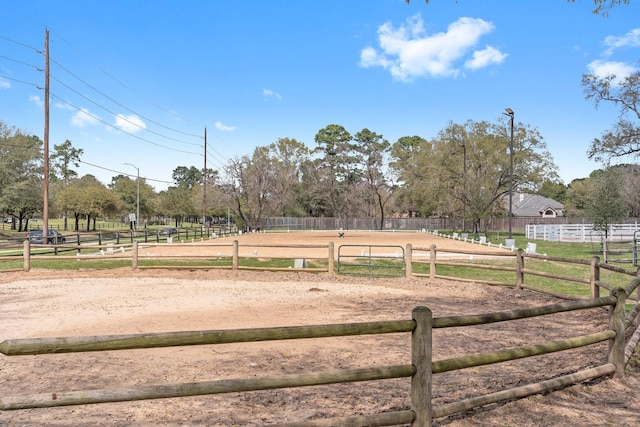 view of yard featuring an enclosed area and a rural view