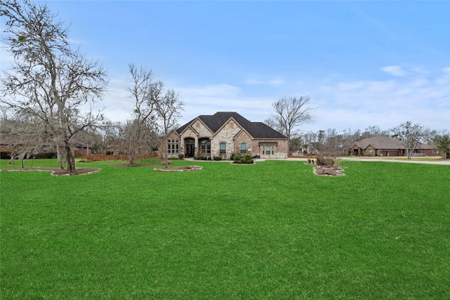 exterior space featuring stone siding and a front lawn