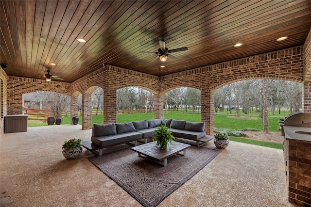 view of patio / terrace with outdoor lounge area, a grill, a ceiling fan, and an outdoor kitchen