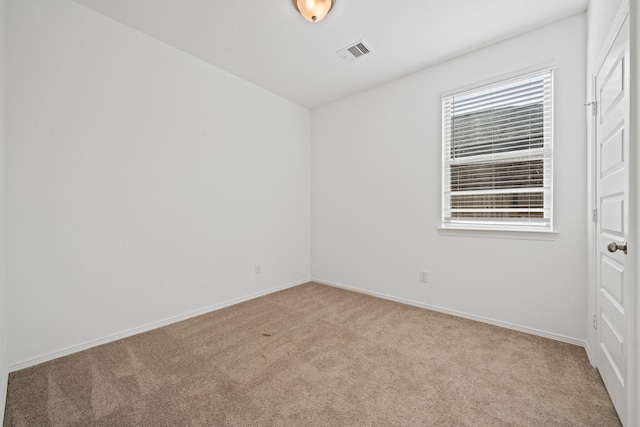 unfurnished room with carpet flooring, baseboards, and visible vents