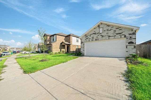 view of front of house with brick siding, concrete driveway, a front lawn, and fence