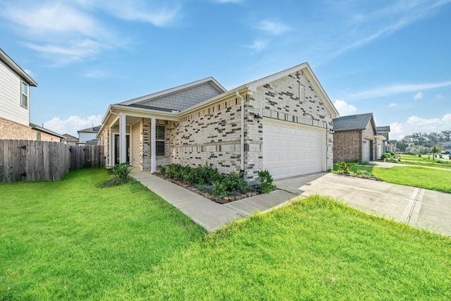 view of front facade featuring driveway, fence, a front yard, a garage, and brick siding