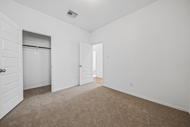 unfurnished bedroom featuring a closet, visible vents, carpet flooring, and baseboards