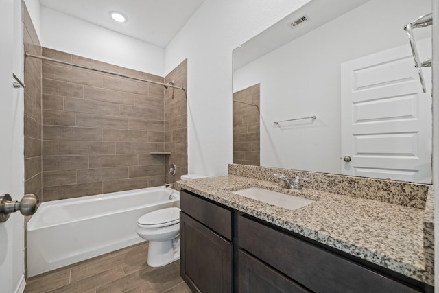 full bathroom featuring vanity, toilet, tub / shower combination, and visible vents