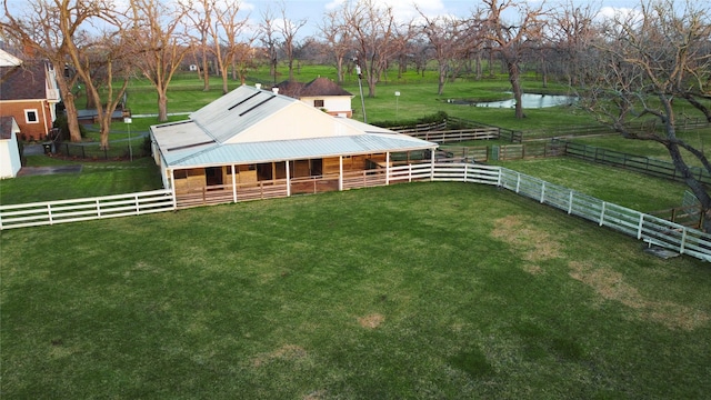 view of yard featuring an exterior structure and a water view