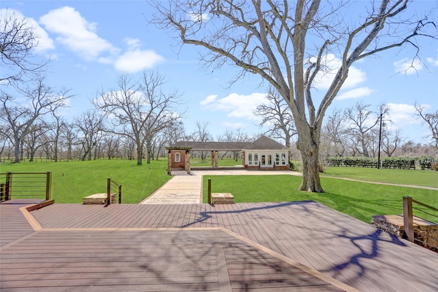 wooden terrace featuring a lawn