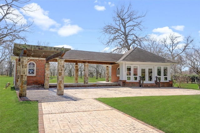 view of community featuring a lawn and a pergola