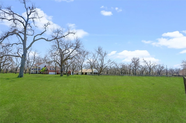 view of yard featuring a rural view and fence