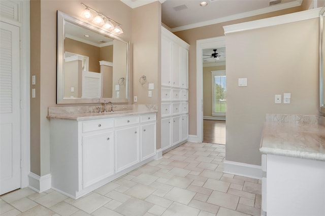 bathroom featuring baseboards, vanity, ceiling fan, and crown molding