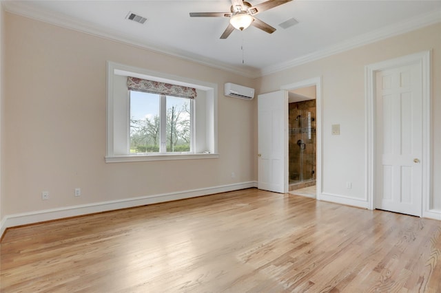 unfurnished bedroom with a wall mounted air conditioner, visible vents, light wood-type flooring, and crown molding