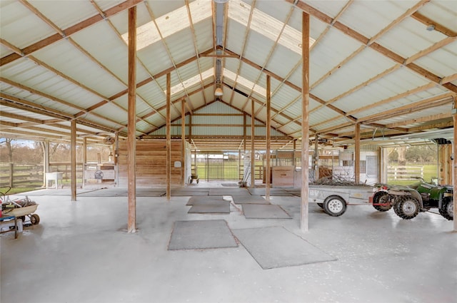 interior space with high vaulted ceiling and metal wall