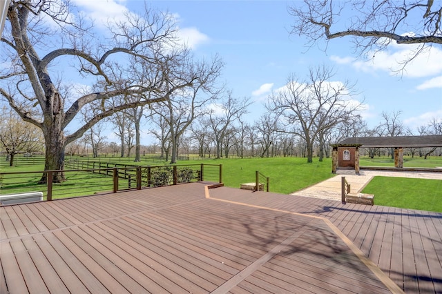 deck featuring a rural view and a lawn