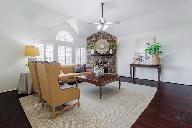 living area featuring a fireplace, wood finished floors, a ceiling fan, and vaulted ceiling