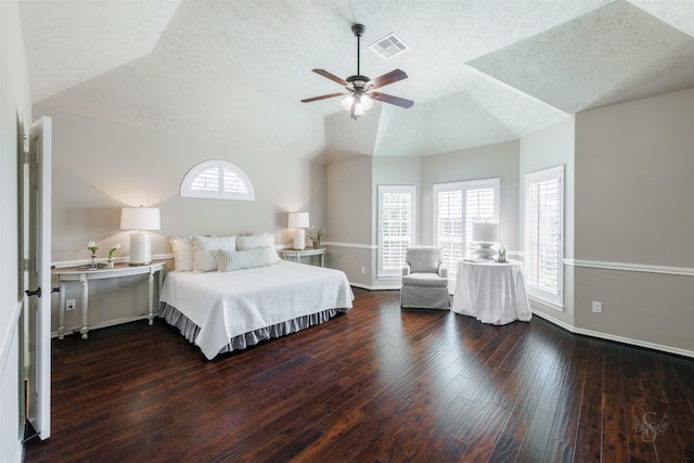 bedroom with hardwood / wood-style flooring, baseboards, visible vents, and lofted ceiling