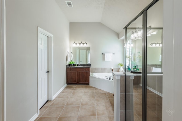 bathroom with tile patterned flooring, visible vents, lofted ceiling, a bath, and vanity