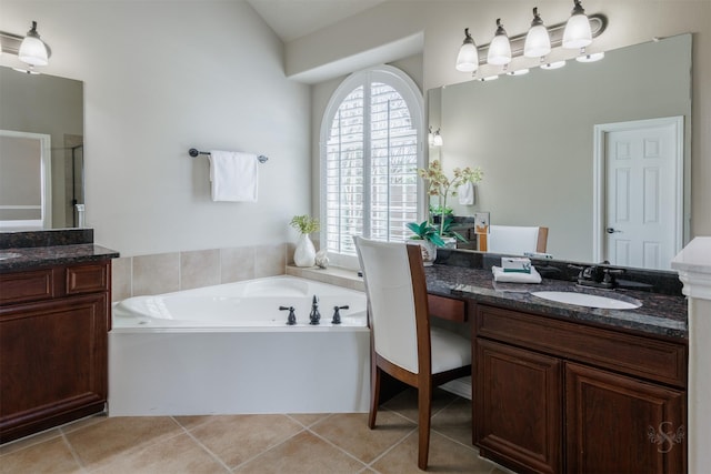 bathroom featuring vanity, tile patterned floors, a bath, and a shower stall