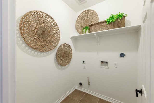 laundry area featuring electric dryer hookup, dark tile patterned flooring, hookup for a gas dryer, hookup for a washing machine, and laundry area