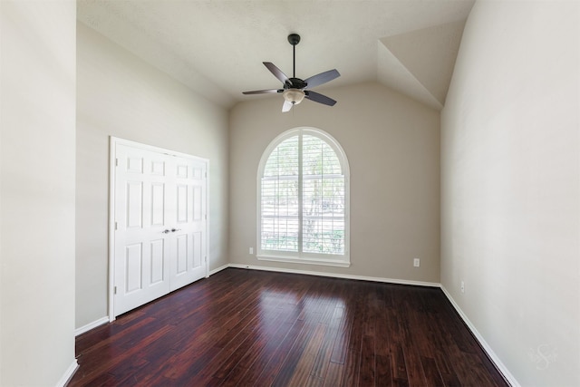 unfurnished bedroom with vaulted ceiling, baseboards, and dark wood-style flooring