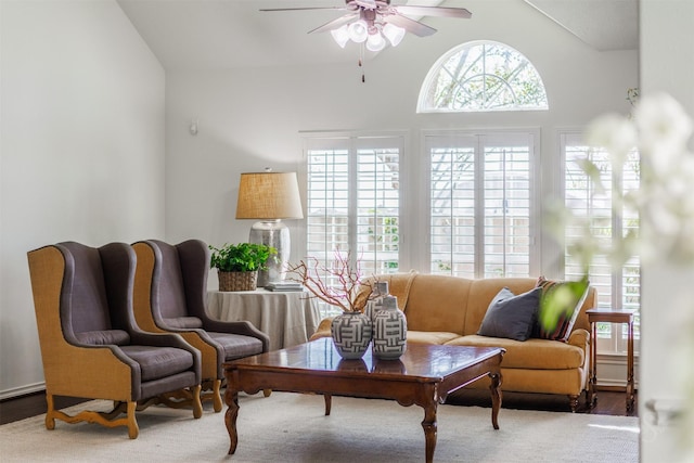 living area featuring vaulted ceiling and a ceiling fan