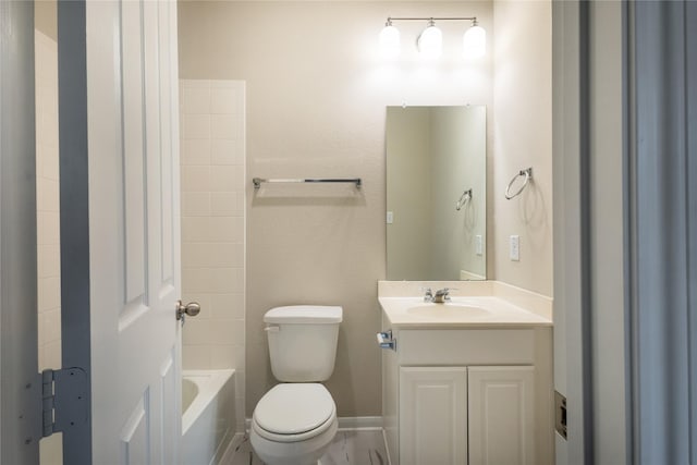 bathroom with vanity, shower / tub combination, toilet, and baseboards