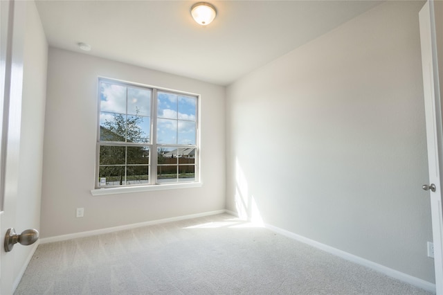 unfurnished room featuring baseboards and carpet floors