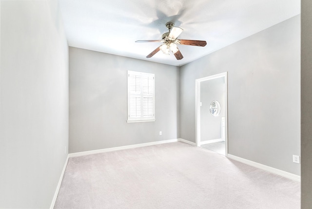 unfurnished room featuring carpet flooring, baseboards, and a ceiling fan