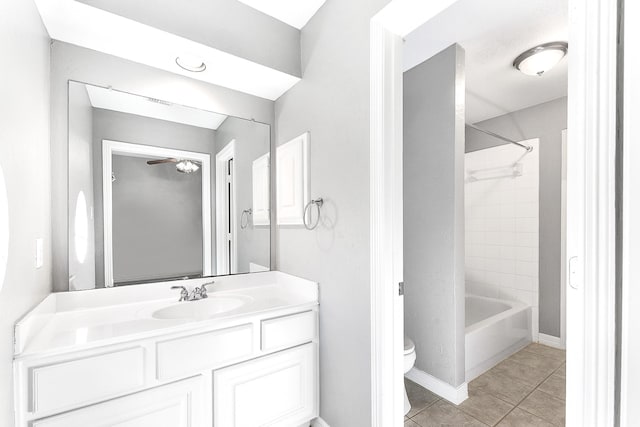 bathroom featuring tile patterned floors, toilet, shower / washtub combination, baseboards, and vanity