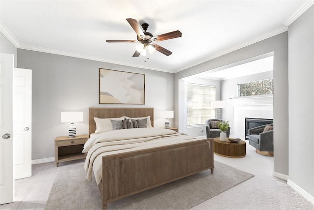 carpeted bedroom with a tiled fireplace, crown molding, a ceiling fan, and baseboards