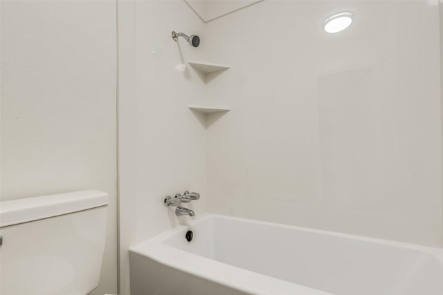 bathroom featuring toilet and bathing tub / shower combination