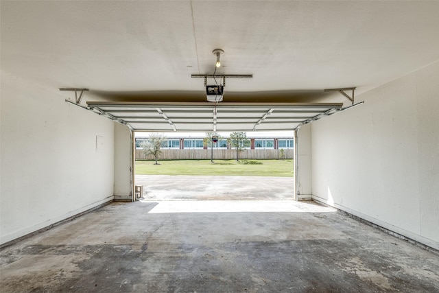 garage with a garage door opener and baseboards