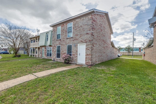 view of front of house with brick siding and a front yard