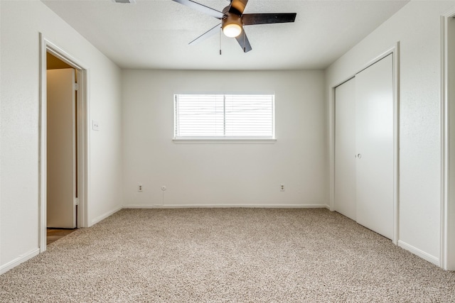 unfurnished bedroom with a closet, carpet flooring, and ceiling fan