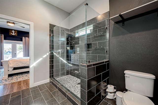 108 Bay Oaks Dr, La Porte, TX 77571 - ensuite bathroom featuring toilet, french doors, tiled shower, wood finished floors, and ensuite bath