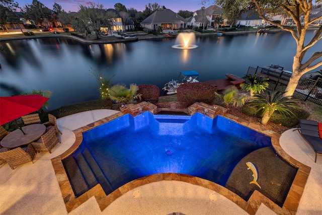 view of swimming pool featuring fence, a water view, and a residential view