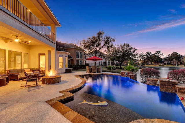 pool featuring an outdoor living space with a fire pit and a patio area