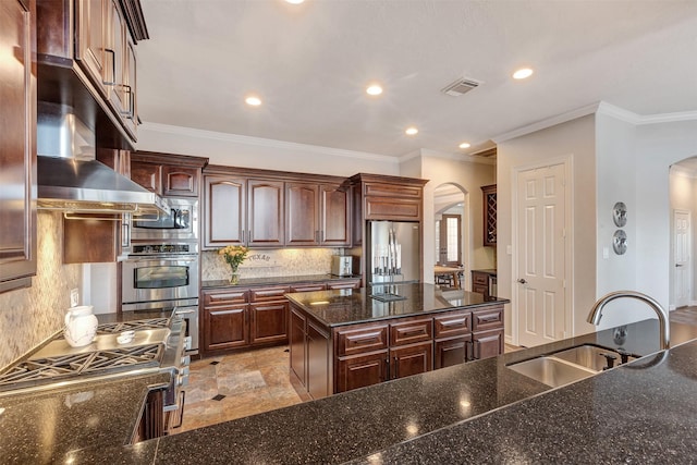 kitchen with a sink, extractor fan, arched walkways, and stainless steel appliances