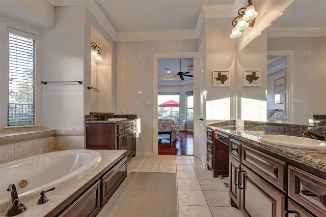 bathroom with tile patterned flooring, crown molding, a whirlpool tub, ensuite bath, and a sink