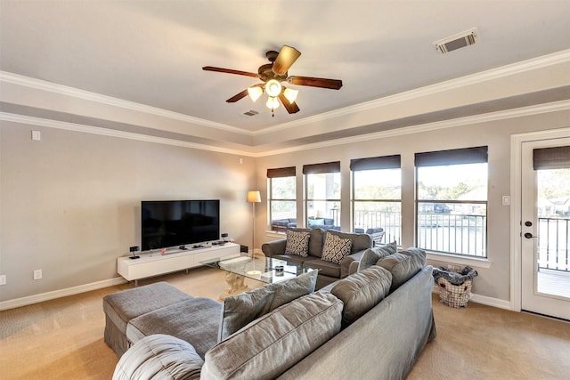 living area featuring visible vents, light colored carpet, a healthy amount of sunlight, and a ceiling fan