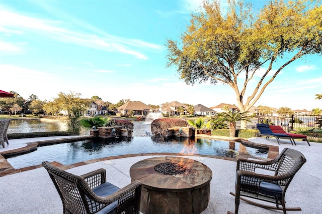 view of patio / terrace with fence, a residential view, and an outdoor fire pit