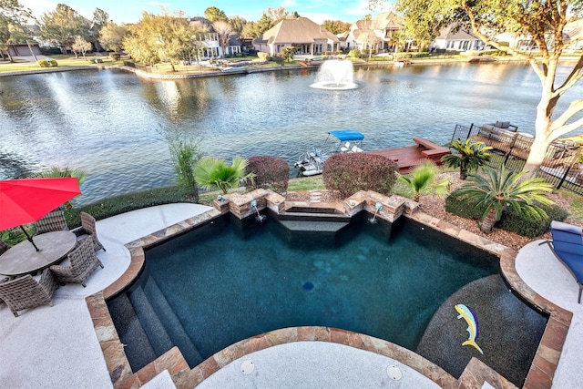 view of pool featuring a jacuzzi, a residential view, and a water view