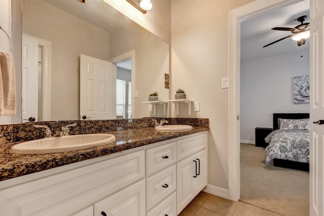 bathroom featuring tile patterned flooring, ensuite bath, double vanity, and a sink