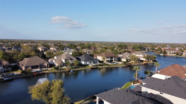 drone / aerial view featuring a residential view and a water view